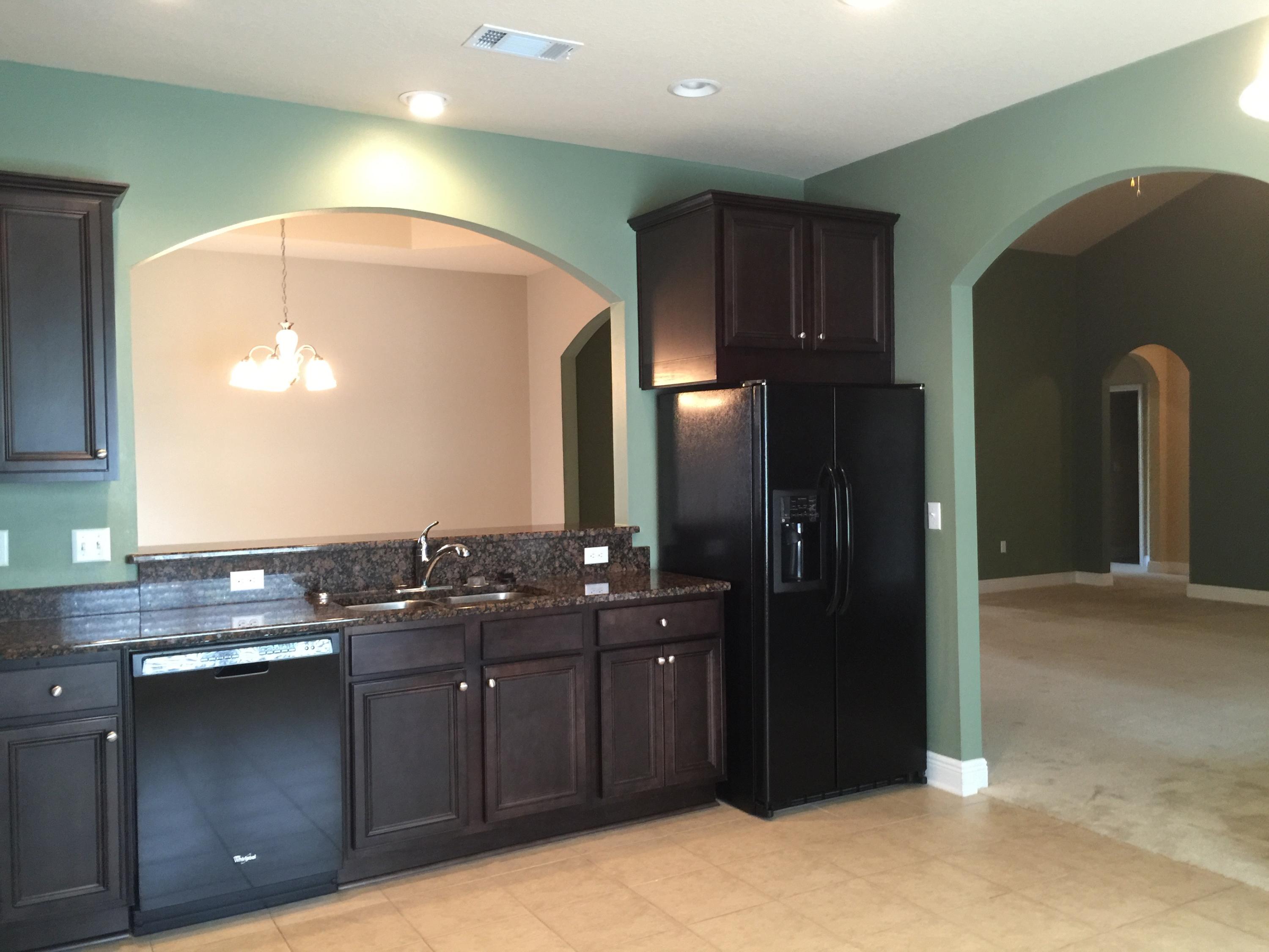 660 Red Fern Road Crestview, FL 32536 - Photo 14 of 32 a kitchen with stainless steel appliances granite countertop a refrigerator and a sink