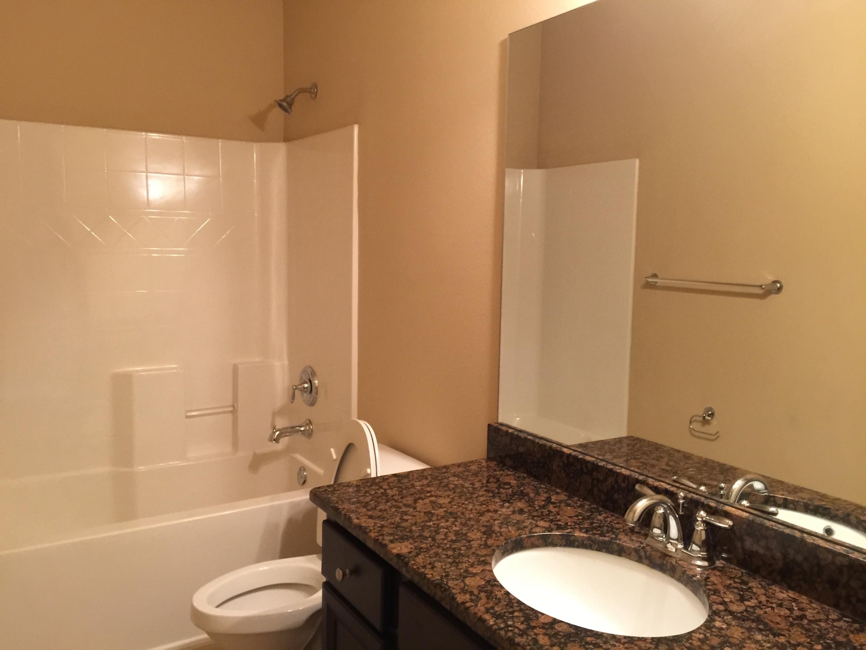 660 Red Fern Road Crestview, FL 32536 - Photo 24 of 32 a bathroom with a granite countertop sink toilet a mirror and shower