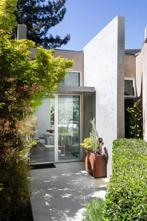 a view of a patio with table and chairs and potted plants