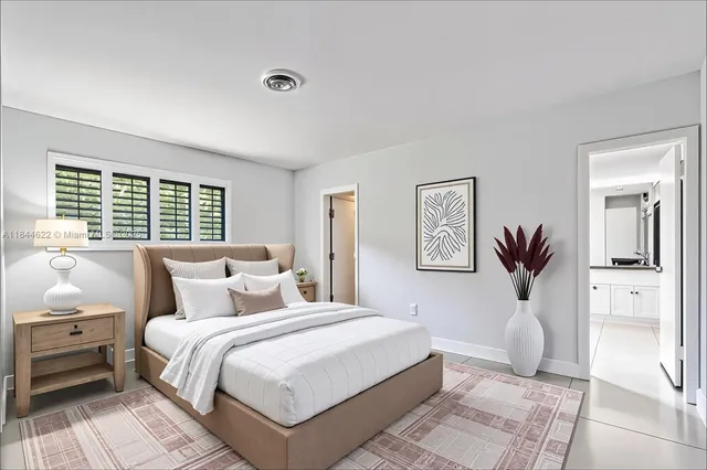 a bedroom with a large bed and a window