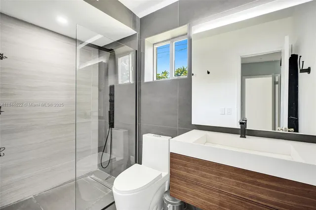 a bathroom with a sink toilet and shower