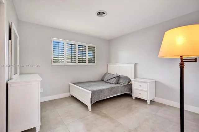 a bedroom with a bed and a table