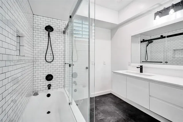a bathroom with a sink a mirror and shower