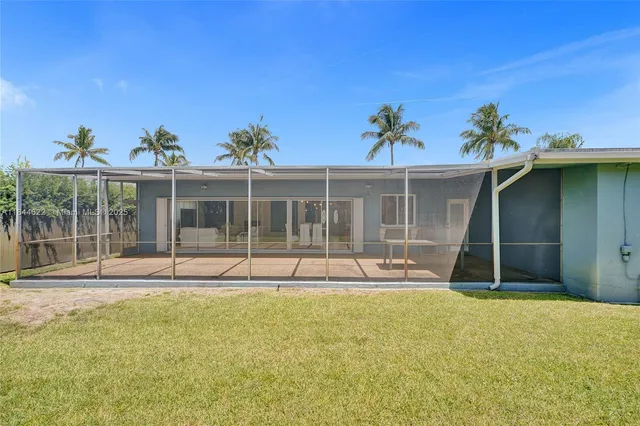 a view of a house with backyard and porch