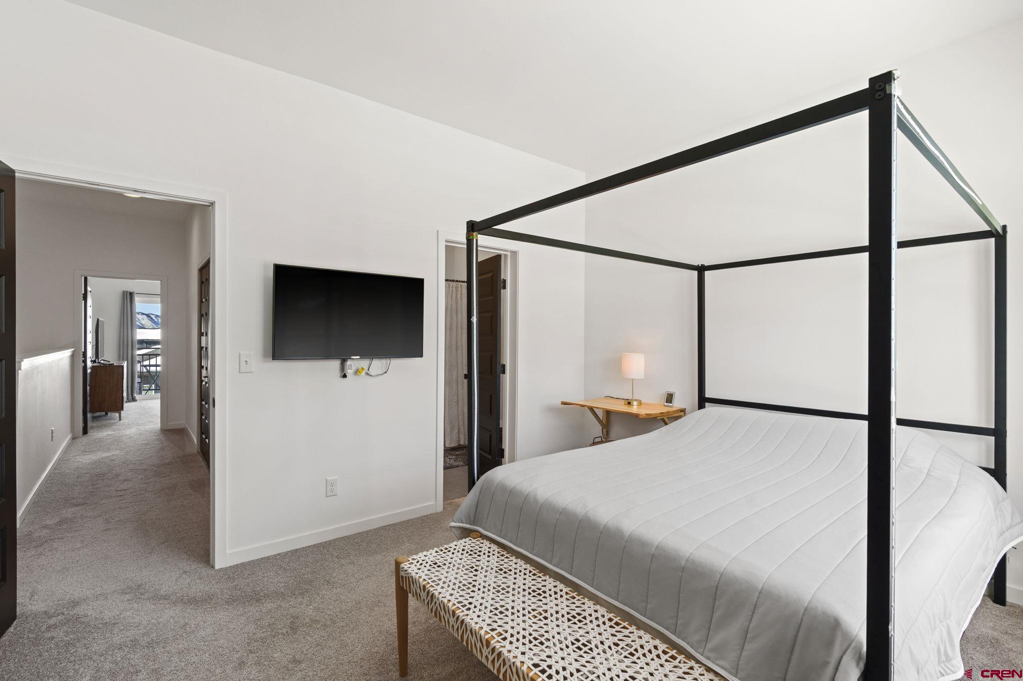 220 Metz Lane, Unit 603 Durango, CO 81301 - Photo 14 of 21 a bedroom with a large bed and a flat screen tv