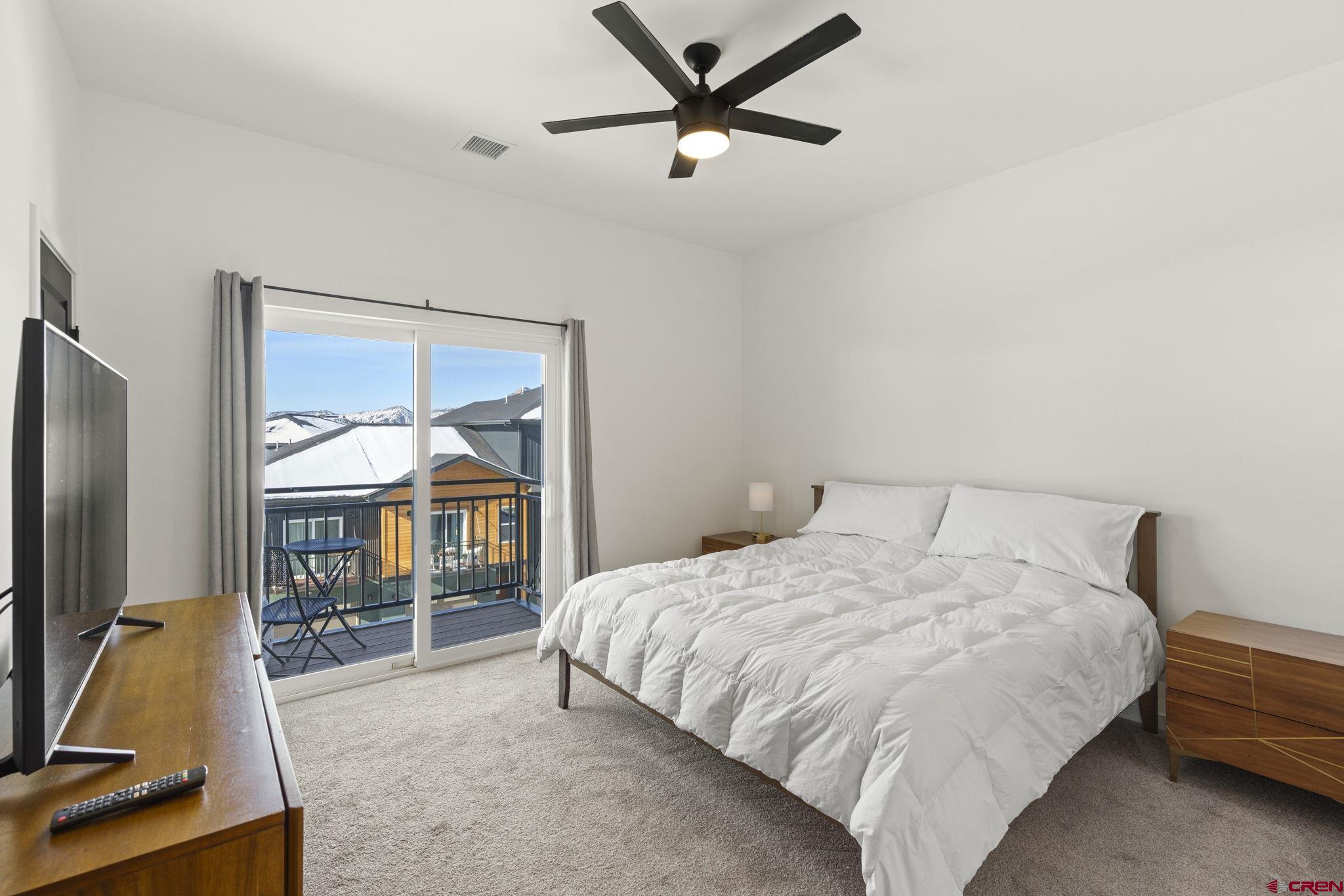 220 Metz Lane, Unit 603 Durango, CO 81301 - Photo 8 of 21 a bedroom with a bed and a flat screen tv
