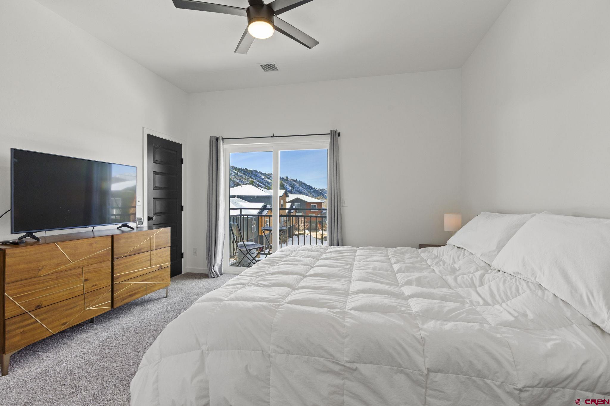 220 Metz Lane, Unit 603 Durango, CO 81301 - Photo 9 of 21 a bedroom with a bed and a flat screen tv