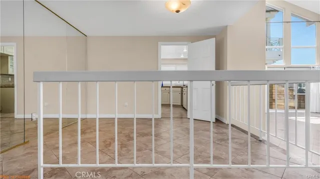 a kitchen with granite countertop white cabinets and a window