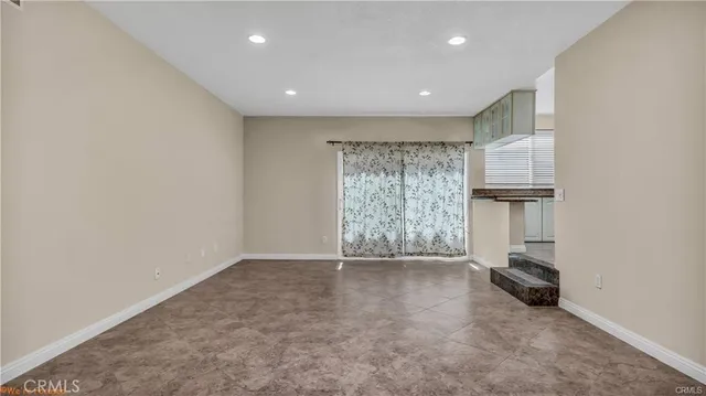 a view of a room with wooden floor and a window