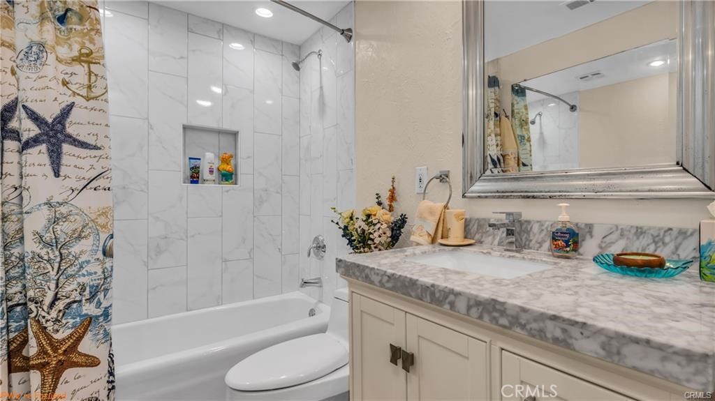 16661 Carousel Lane Huntington Beach, CA 92649 - Photo 27 of 47 a bathroom with a granite countertop sink a toilet and shower