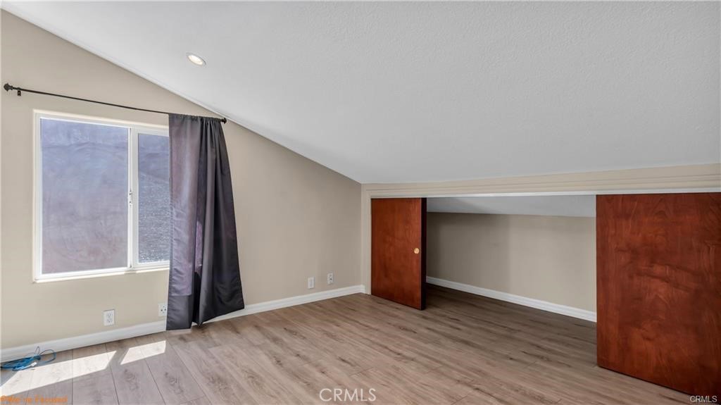 16661 Carousel Lane Huntington Beach, CA 92649 - Photo 35 of 47 a view of an empty room with wooden floor and a window