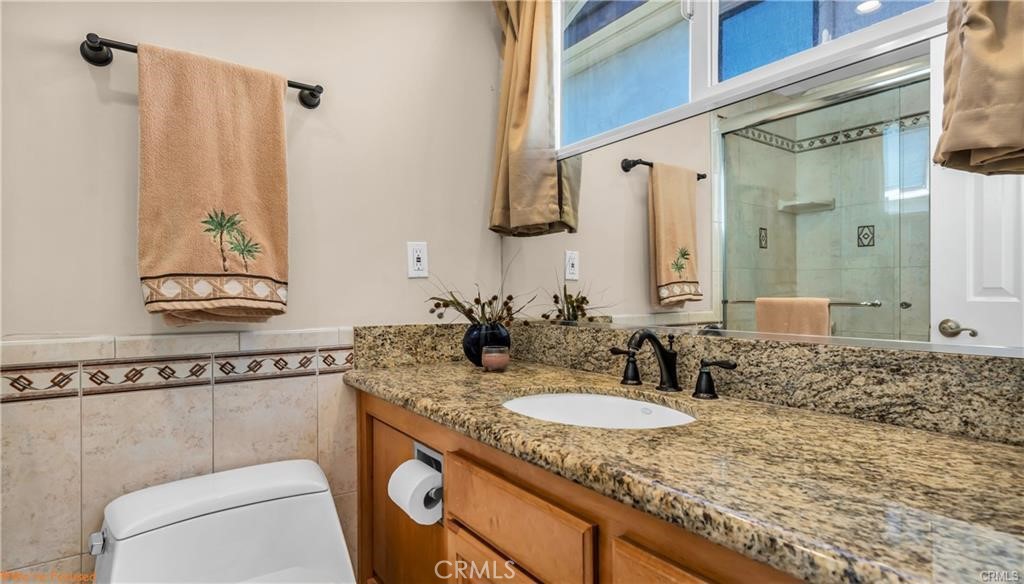 16661 Carousel Lane Huntington Beach, CA 92649 - Photo 36 of 47 a bathroom with a granite countertop sink and a mirror