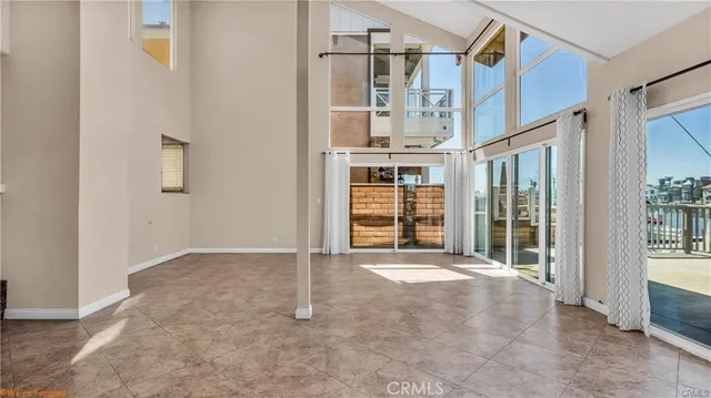 an empty room with staircase and door