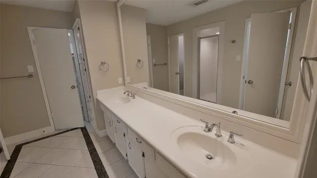 a bathroom with a double vanity sink and mirror