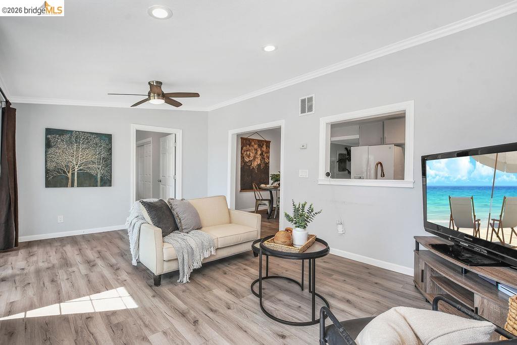 2191 East Cypress Road Oakley, CA 94561 - Photo 13 of 48 Living room with light wood-style flooring, crown molding, a ceiling fan, and recessed lighting