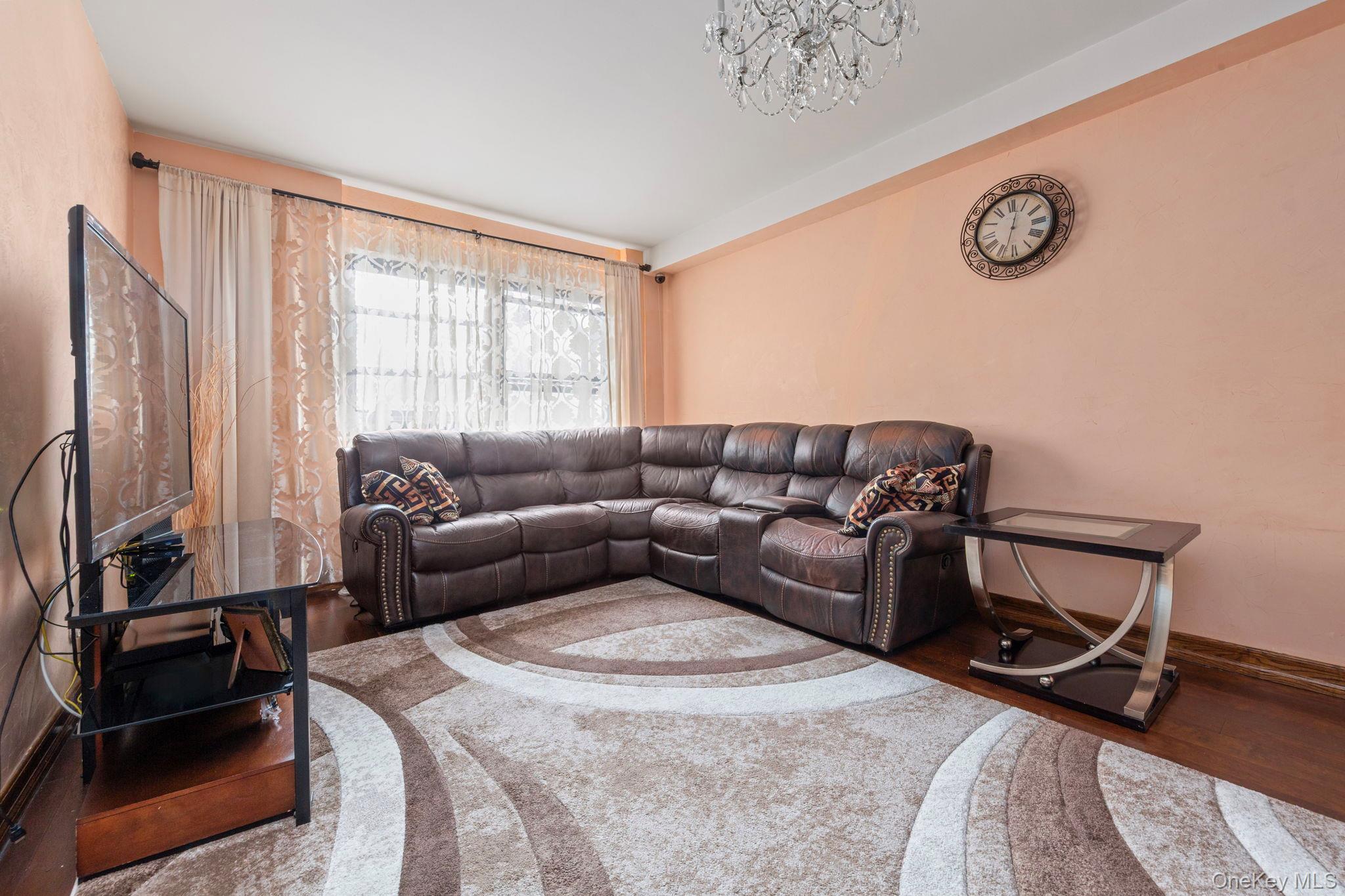 99-72 66th Road, Unit 1Z Queens, NY 11374 - Photo 2 of 16 a living room with furniture and a window