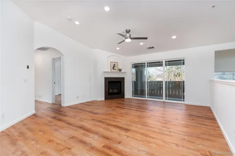 a view of an empty room with a fireplace and a window