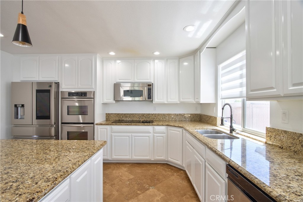 23126 Teil Glen Road Wildomar, CA 92595 - Photo 12 of 48 a kitchen with stainless steel appliances granite countertop a sink stove and refrigerator