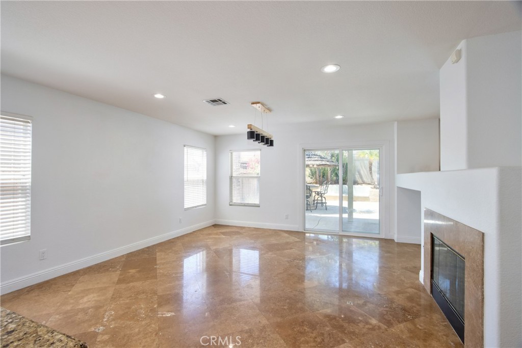 23126 Teil Glen Road Wildomar, CA 92595 - Photo 17 of 48 a view of an empty room with wooden floor and a window