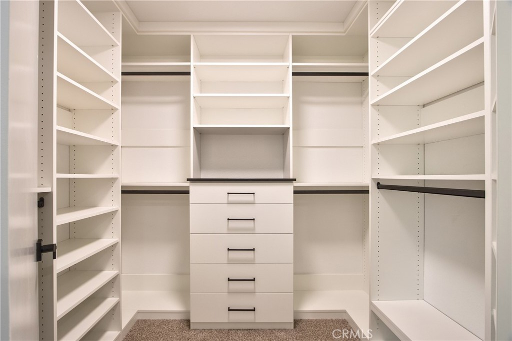 23126 Teil Glen Road Wildomar, CA 92595 - Photo 24 of 48 a view of walk in closet with empty racks