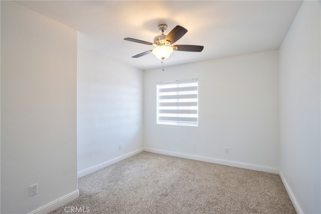 23126 Teil Glen Road Wildomar, CA 92595 - Photo 35 of 48 an empty room with a window and a fan