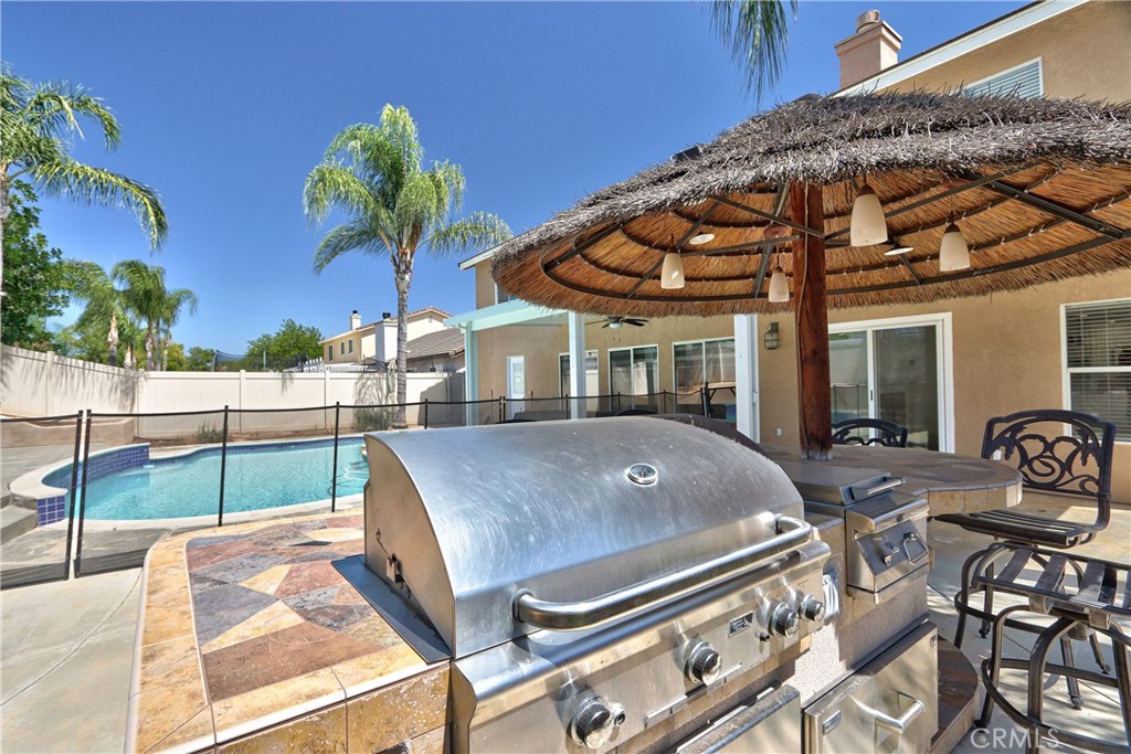 23126 Teil Glen Road Wildomar, CA 92595 - Photo 38 of 48 a view of a patio with table and chairs potted plants
