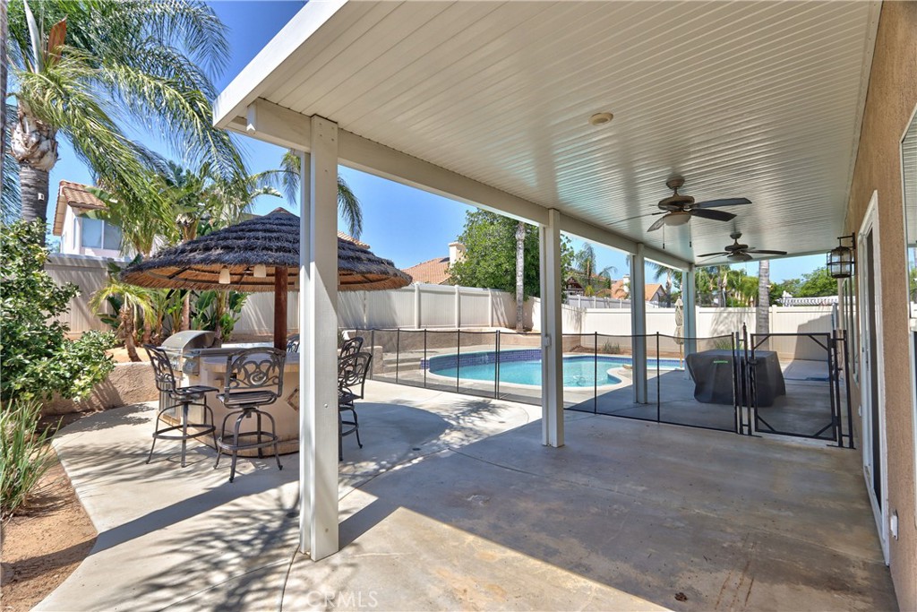 23126 Teil Glen Road Wildomar, CA 92595 - Photo 40 of 48 a view of a patio with table and chairs potted plants with wooden fence
