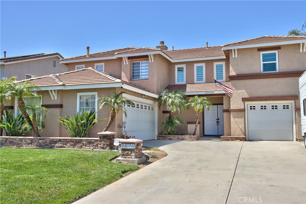 23126 Teil Glen Road Wildomar, CA 92595 - Photo 4 of 48 a front view of a house with a garden and plants