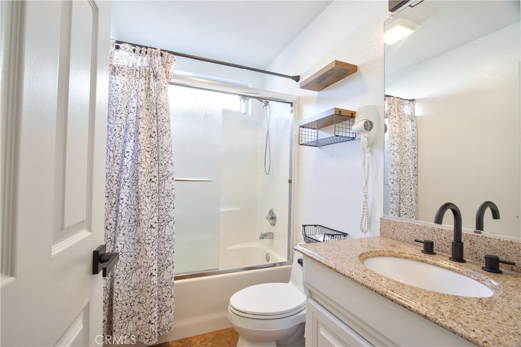 23126 Teil Glen Road Wildomar, CA 92595 - Photo 48 of 48 a bathroom with a granite countertop sink a toilet and shower