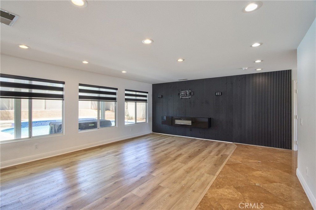23126 Teil Glen Road Wildomar, CA 92595 - Photo 5 of 48 a view of an empty room with a window and wooden floor