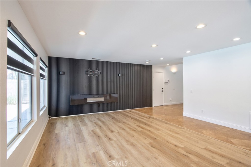 23126 Teil Glen Road Wildomar, CA 92595 - Photo 9 of 48 a view of a big room with wooden floor and windows