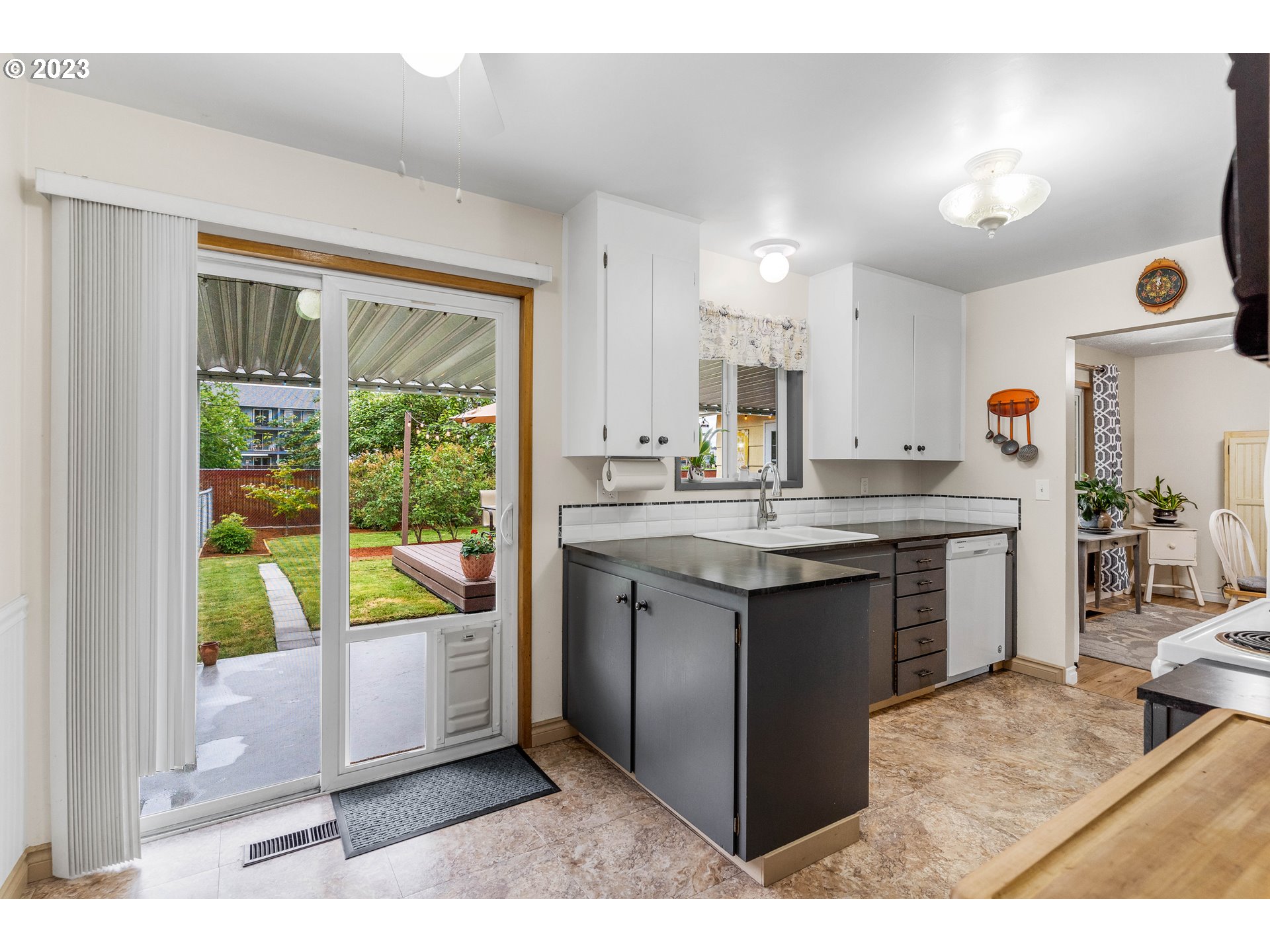 943 Oregon Way Woodburn, OR 97071 - Photo 14 of 39 a kitchen with a sink and white cabinets