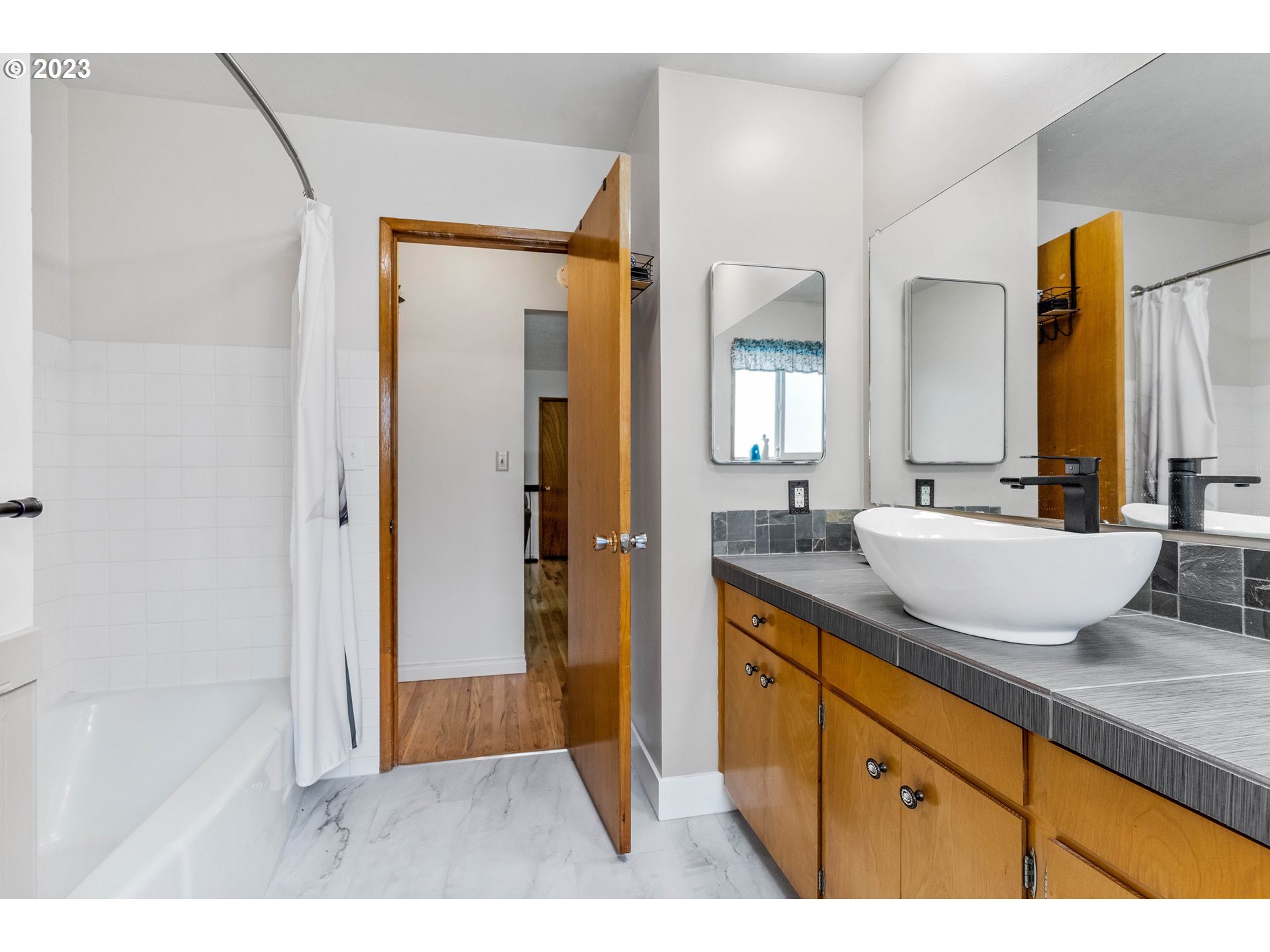 943 Oregon Way Woodburn, OR 97071 - Photo 17 of 39 a bathroom with a granite countertop sink mirror and a shower