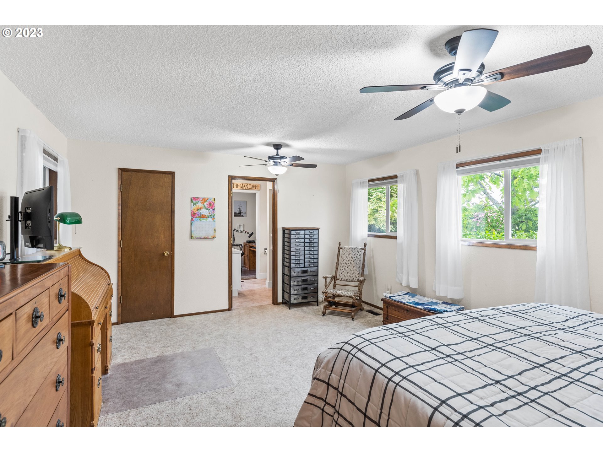 943 Oregon Way Woodburn, OR 97071 - Photo 21 of 39 a bedroom with a bed and a chandelier