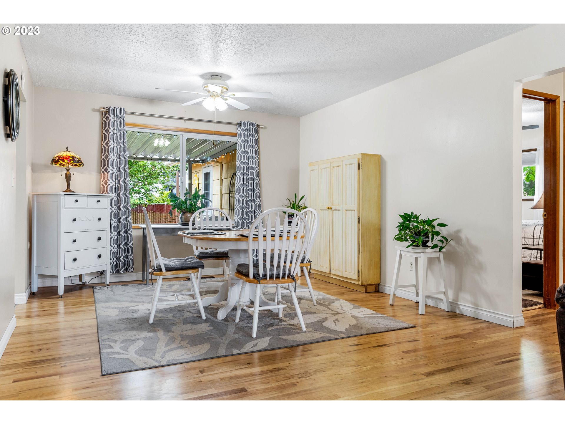 943 Oregon Way Woodburn, OR 97071 - Photo 8 of 39 a dining room with furniture a potted plant and a chandelier