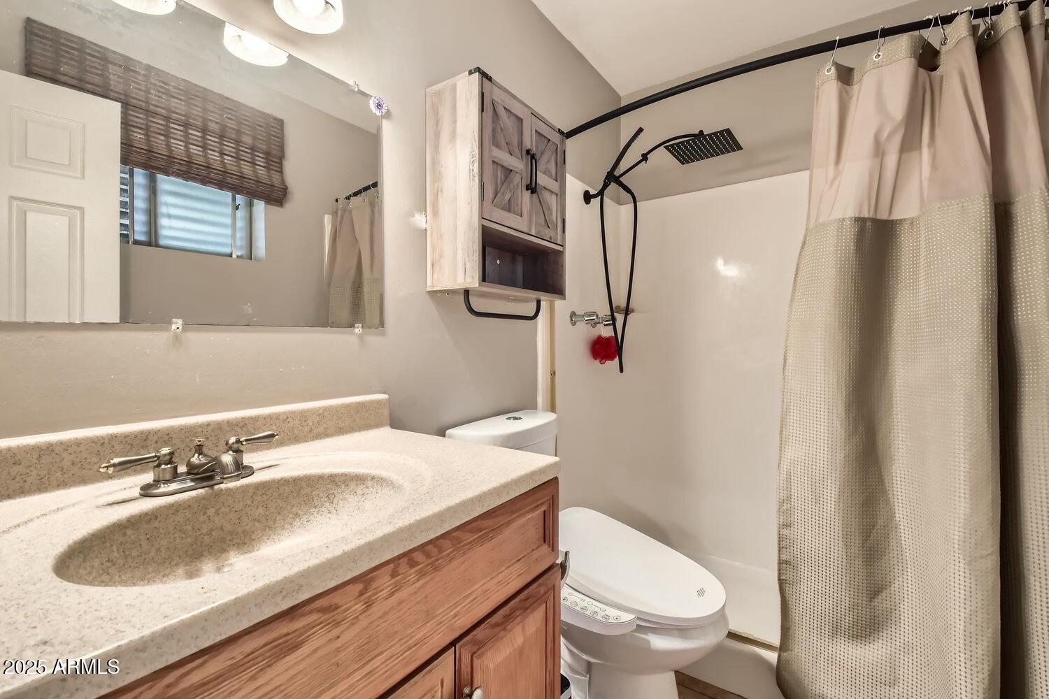 9031 North 14th Street Phoenix, AZ 85020 - Photo 14 of 33 a bathroom with a sink toilet and shower