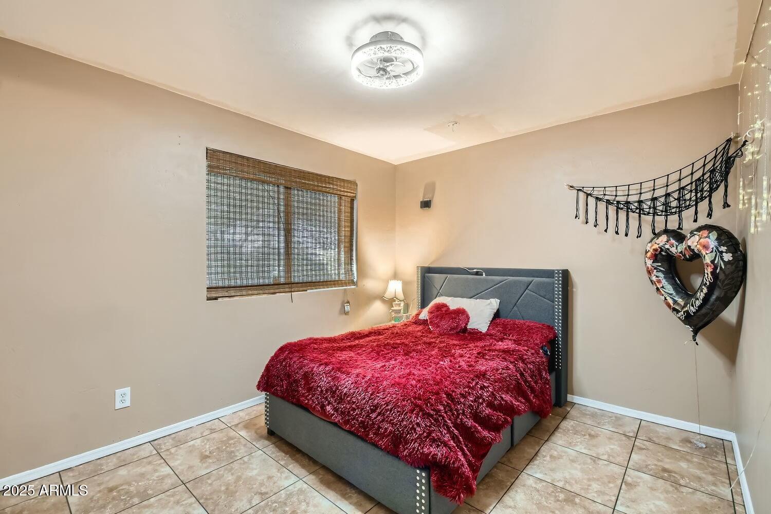 9031 North 14th Street Phoenix, AZ 85020 - Photo 16 of 33 a bedroom with a bed and a window