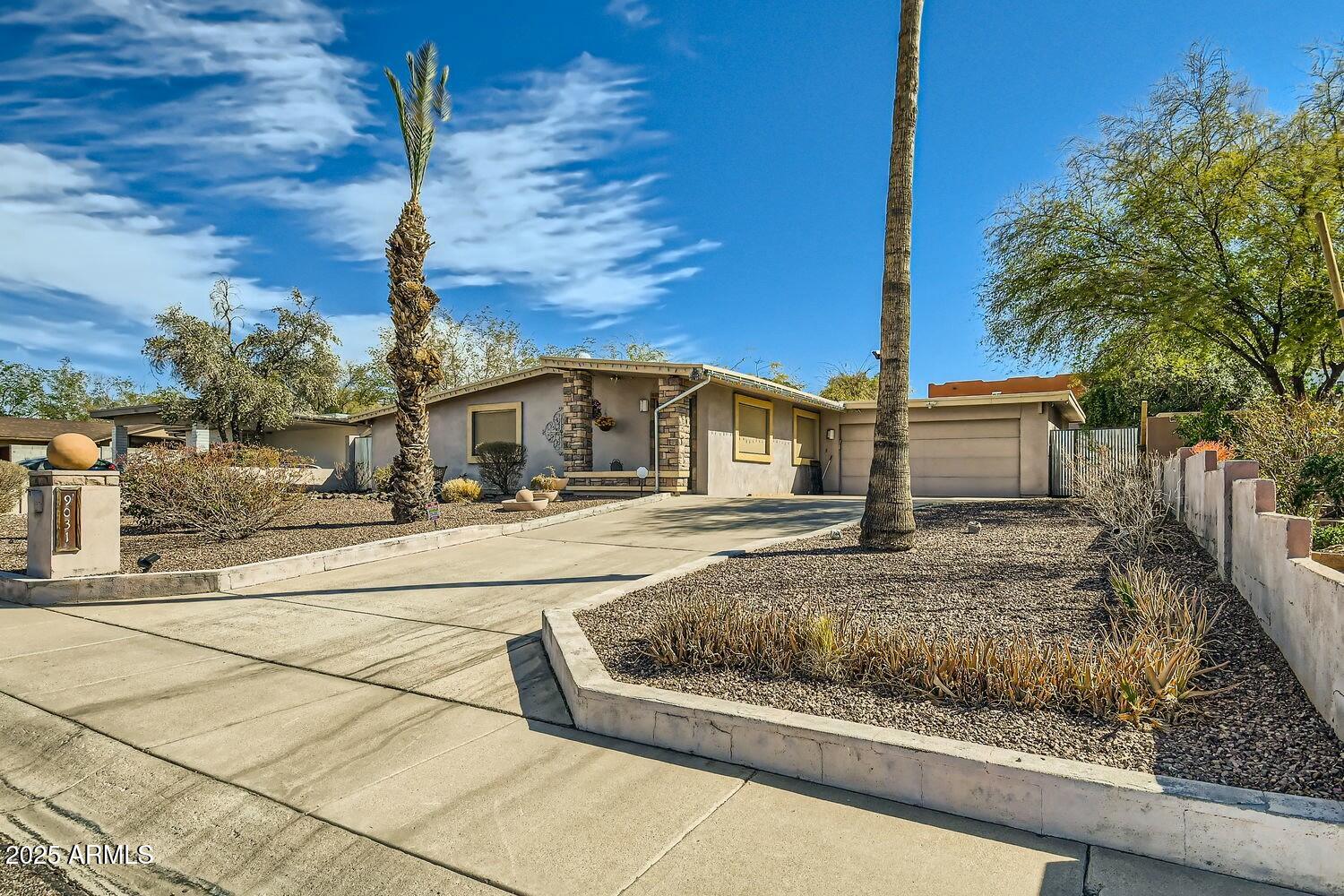 9031 North 14th Street Phoenix, AZ 85020 - Photo 2 of 33 a front view of a house with a yard