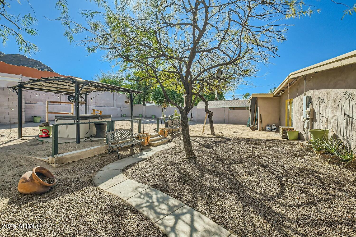 9031 North 14th Street Phoenix, AZ 85020 - Photo 24 of 33 a backyard of a house with barbeque oven table and chairs