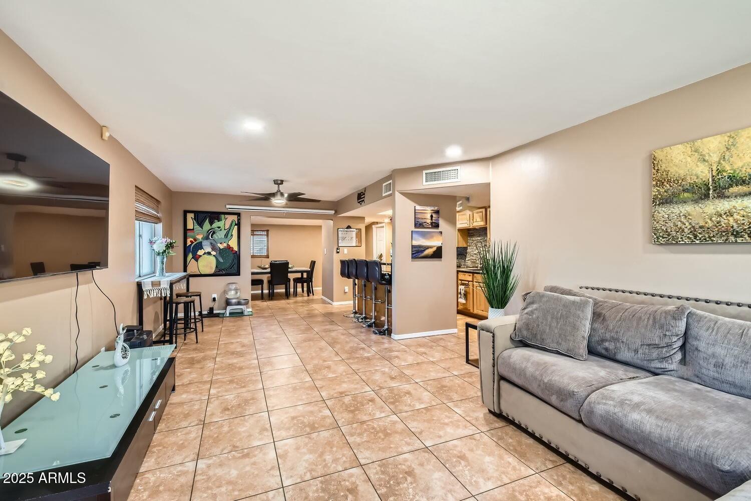 9031 North 14th Street Phoenix, AZ 85020 - Photo 5 of 33 a living room with furniture and a flat screen tv