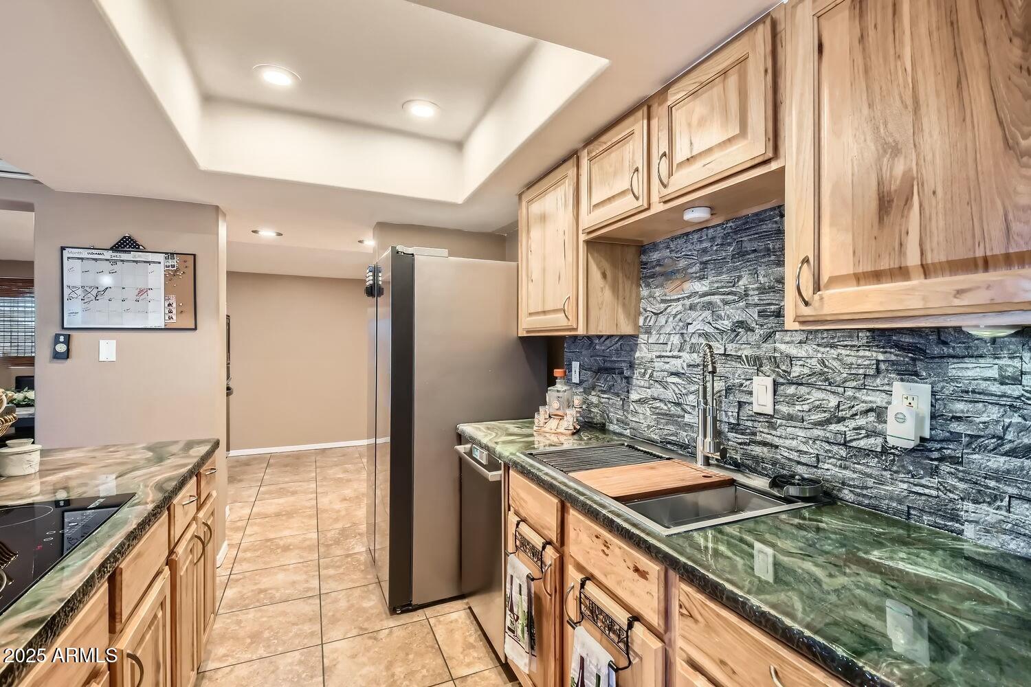 9031 North 14th Street Phoenix, AZ 85020 - Photo 8 of 33 a kitchen that has a sink a stove and a refrigerator