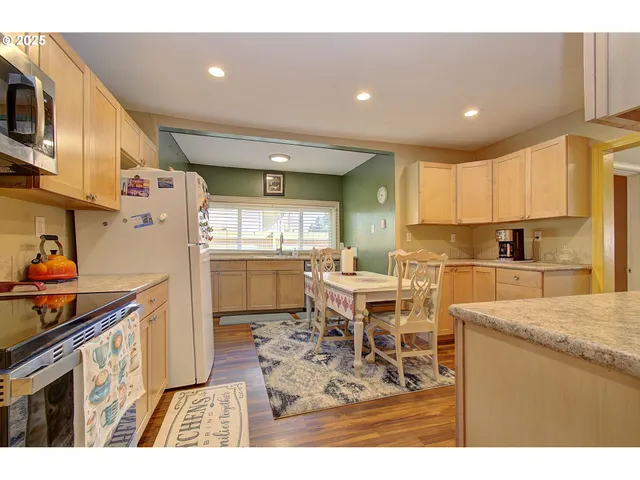 a kitchen with stainless steel appliances kitchen island granite countertop a sink and cabinets