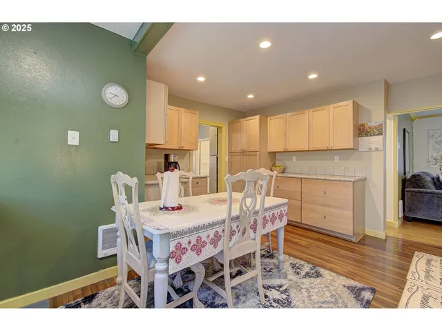 a dining room with furniture and wooden floor