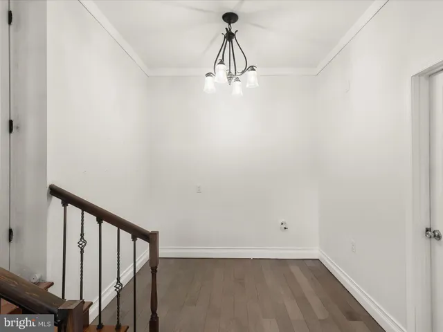 an empty room with fan and windows