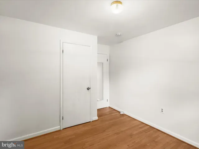 an empty room with fan and windows