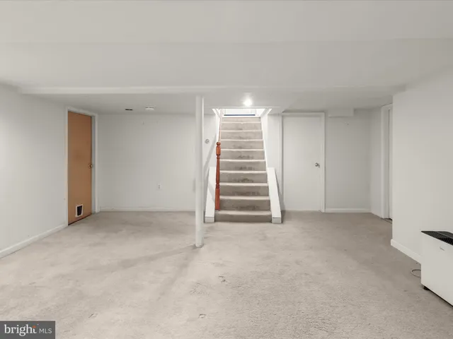 a bathroom with a granite countertop toilet sink and mirror