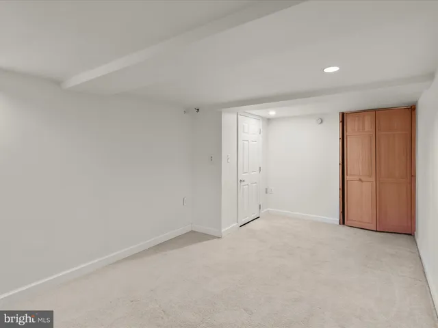 a view of a house with a big yard and large trees