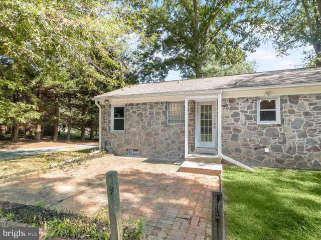 a view of a green field with trees
