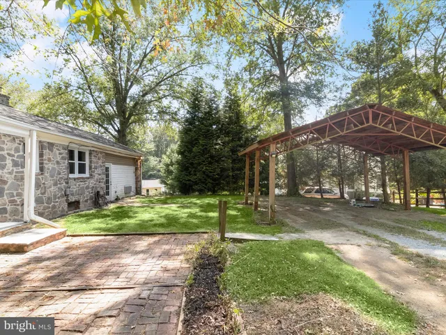 a view of a garden with a house in the background