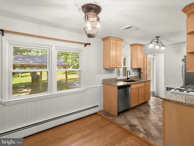 a kitchen with a stove a sink and a refrigerator